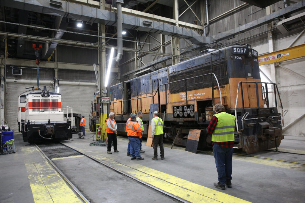 Attendees discuss the locomotive at the 5057 open house in October 2025 