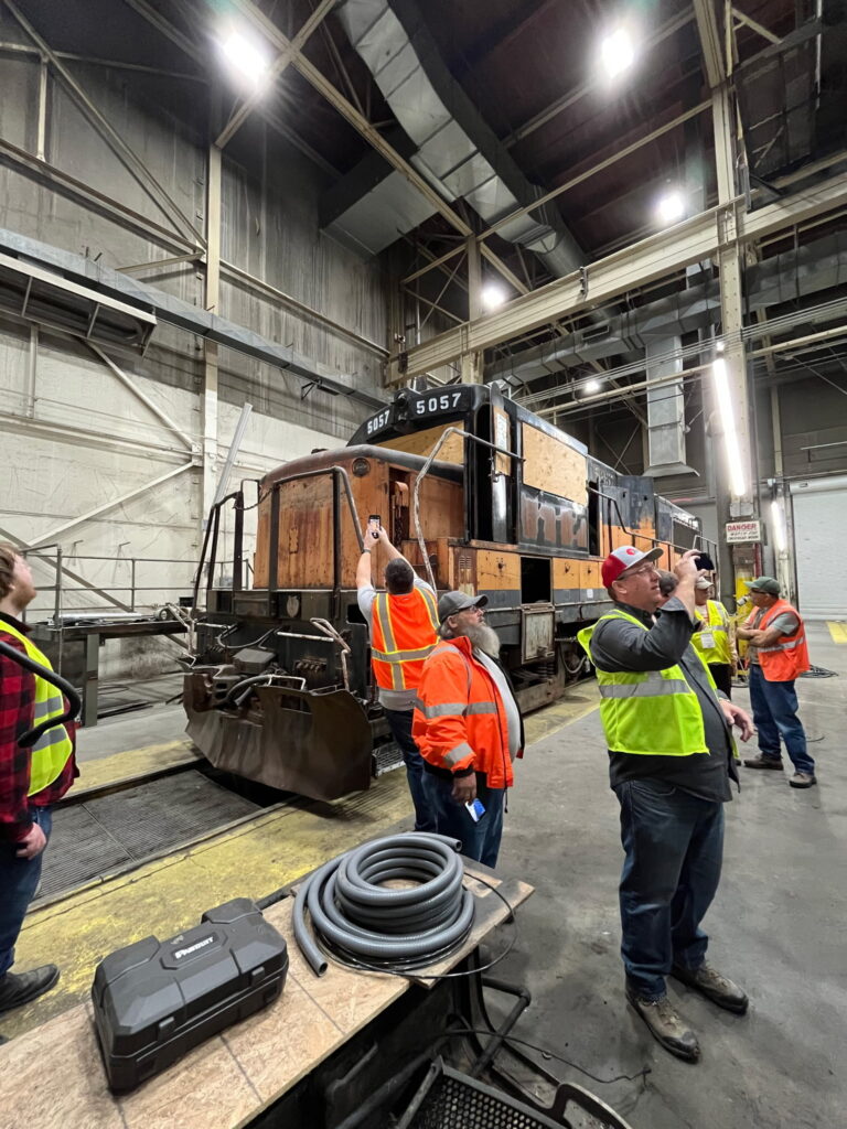 Attendees take photos at the 5057 open house  in October 2025 