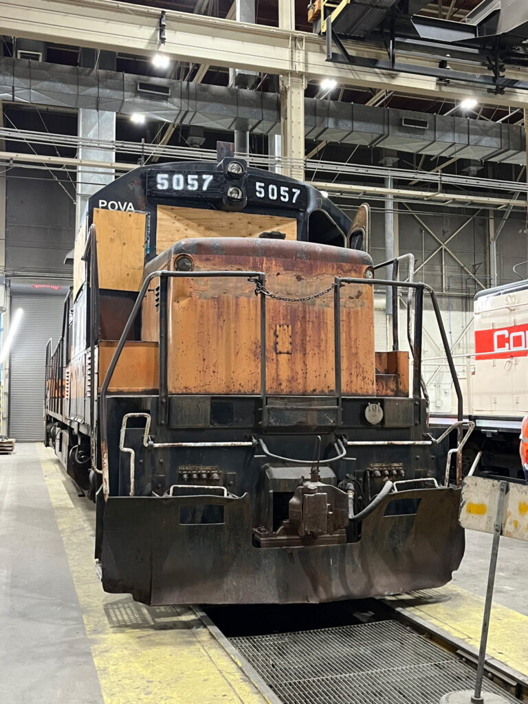 A view showing the front of the 5057 locomotive in the Columbia Rail shop.